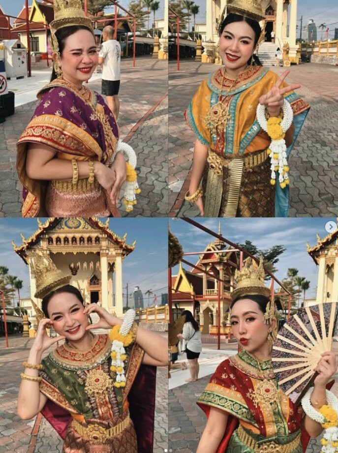 Four dancers in colourful embroidered Thai costumes with gold headdresses and jasmine garlands, posing at a Thai temple